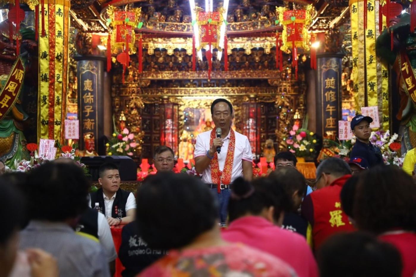 鴻海集團創辦人郭台銘（中）20日到新北慈惠宮進行 「廟口開講」活動。中央社
